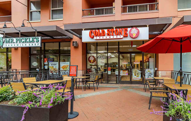 A Hard Stone Creamery storefront with a red umbrella in front.