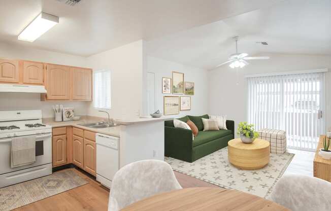 a living room and kitchen with a dining table and a green couch