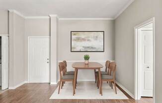 A dining room with a table and chairs.
