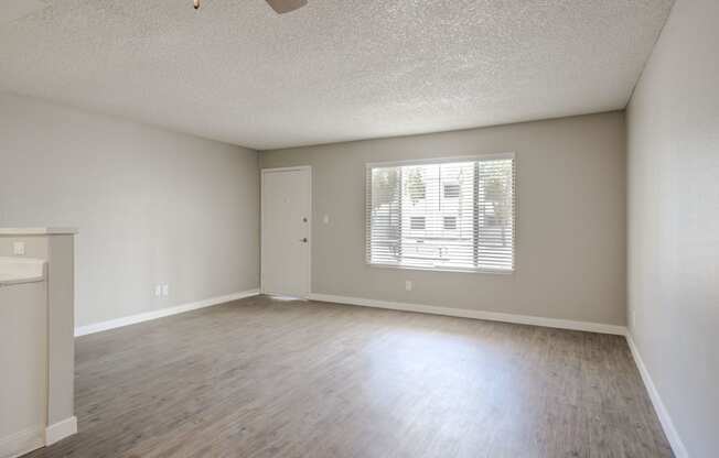 an empty living room with a large window