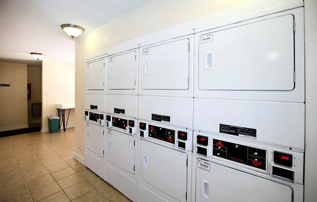 a row of white refrigerators in a room