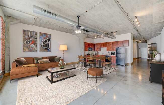 A living room with a brown couch and a coffee table.