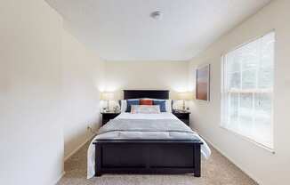 a bedroom with a bed and two nightstands