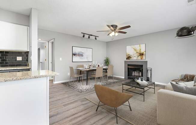 Living room with chair, table, and fireplace at Eddingham in Lawrence, KS