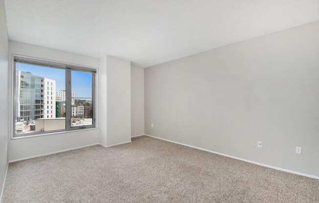 an empty living room with a large window