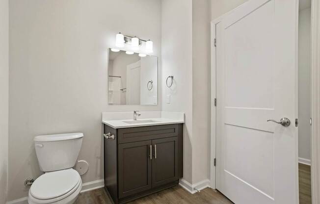 A white toilet sits next to a sink in a bathroom.