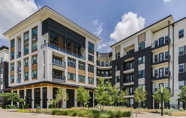 a large apartment building with a street in front of it