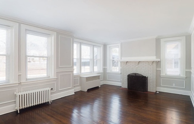 a living room with a fireplace and wooden floors at The Packard, West Hartford, CT, 06119