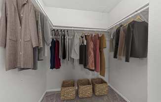 a closet with a rack of clothes and baskets