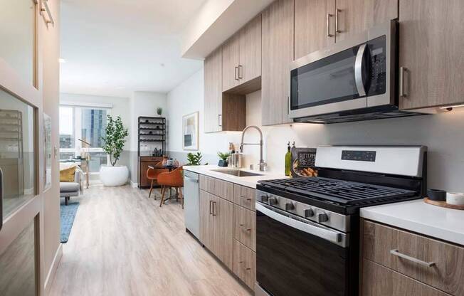 Studio and den layouts available at Modera San Diego featuring quartz countertops, gas ranges with sleek modern design