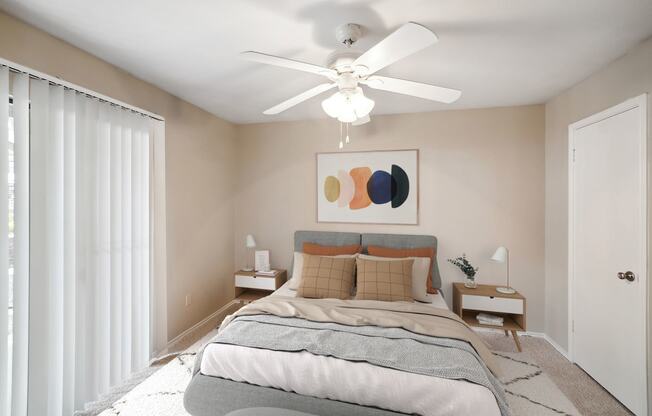 a bedroom with a bed and a ceiling fan