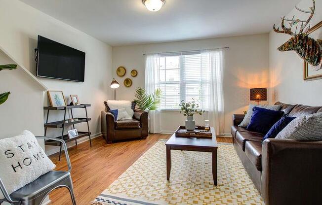 Living room with hardwood floors at Oasis at Cedar Branch in Wilmington, NC