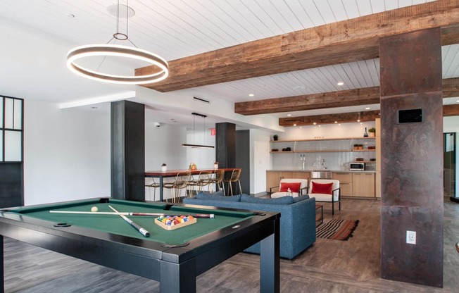 a game room with a pool table and a bar