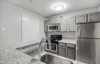 a kitchen with granite counter tops and stainless steel appliances