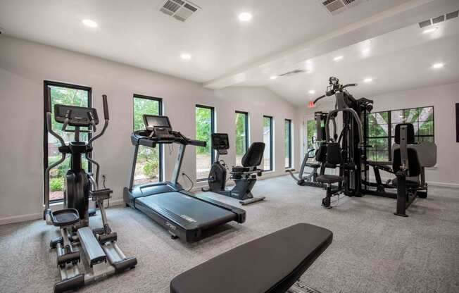 the gym is equipped with state of the art equipment including treadmills and weights