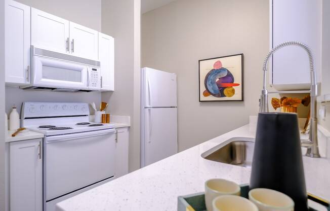 well appointed kitchen with modern white cabinetry at Roosevelt Square apartments in Phoenix