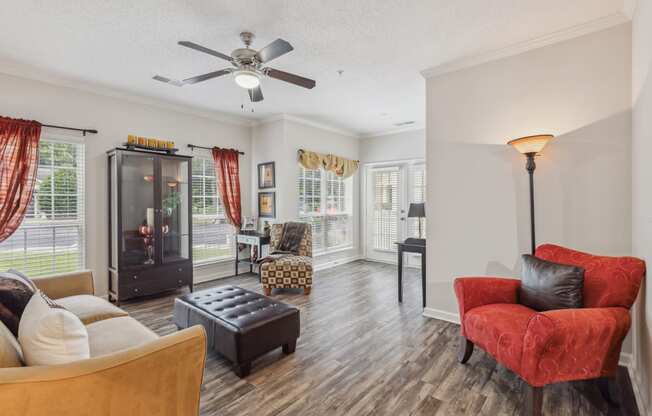 a living room with furniture and a ceiling fan