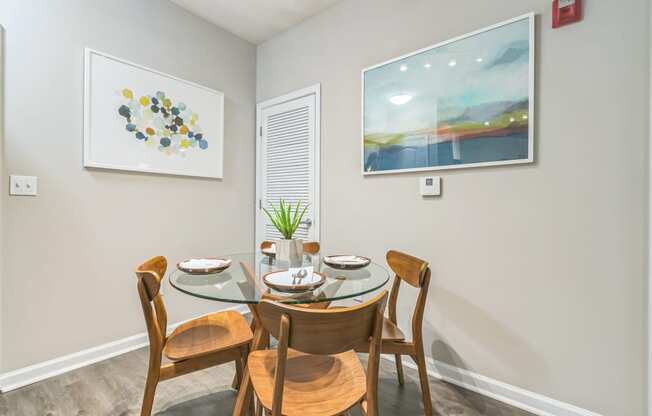 a dining room with a glass table and chairs