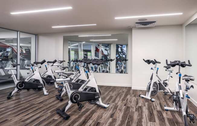 a gym with cardio bikes and other exercise equipment