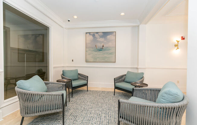 a waiting room with chairs and a painting of two people on a surfboard