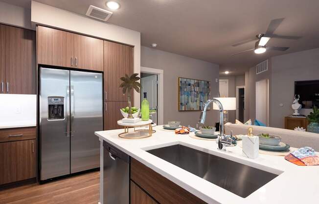 A modern kitchen with a stainless steel refrigerator and wooden cabinets.