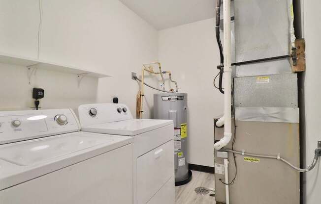 A white washing machine and dryer in a small laundry room.