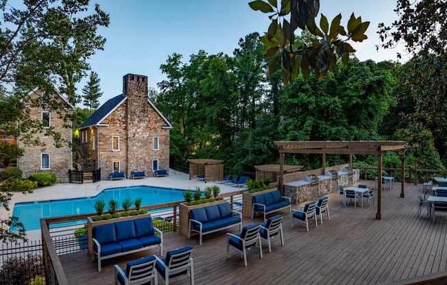 A backyard with a pool and a wooden deck. at Mill House at East Cobb, Marietta