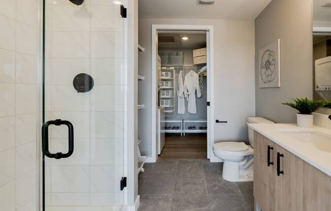 a bathroom with a shower and a sink and a toilet at One Foundry Way, St. Louis, 63110