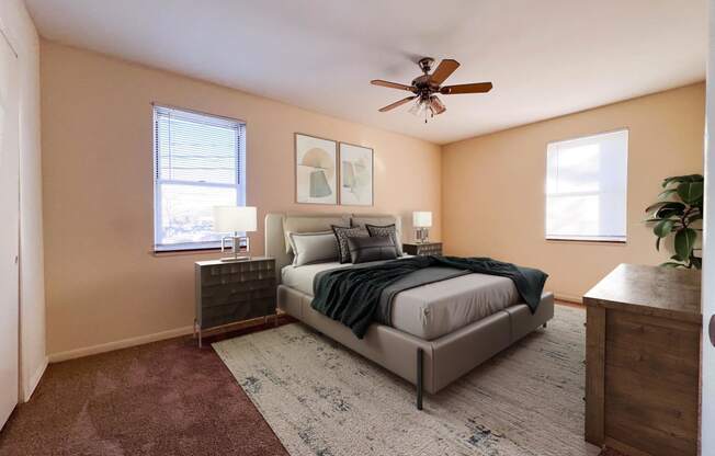 a bedroom with a bed and a ceiling fan