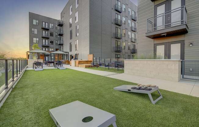 an apartment patio with a table and a fire pit