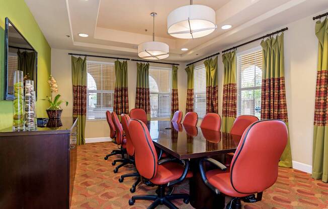A conference room with a long table and chairs.