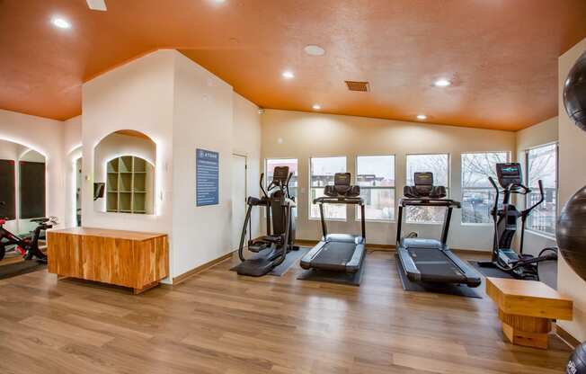 a gym with treadmills and other exercise equipment