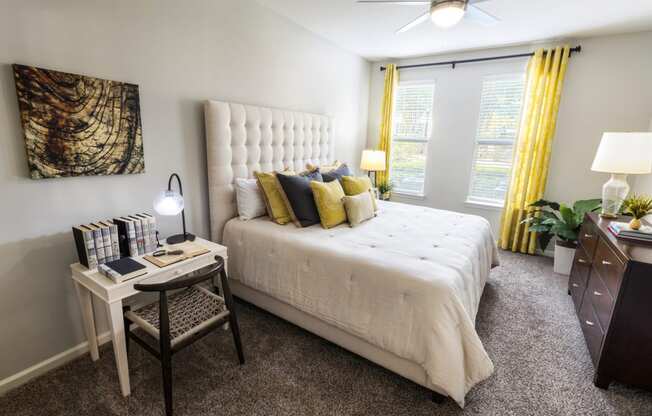 a bedroom with a white bed and yellow curtains