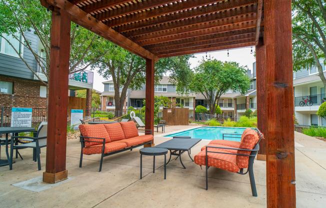 our apartments have a pool and a patio with chairs and tables
