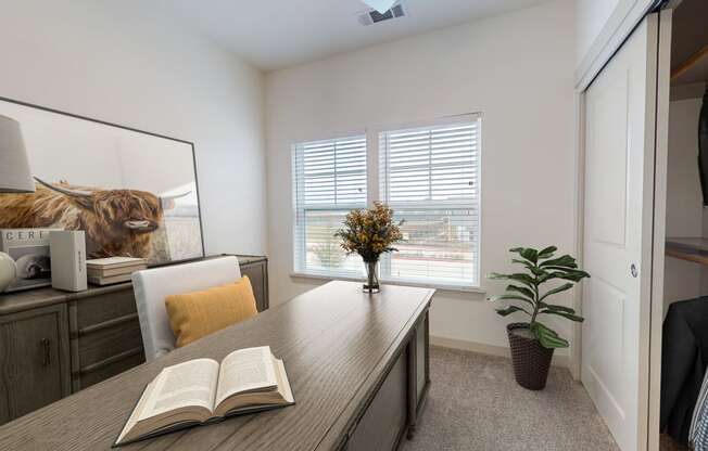 a home office with a desk and a book on it