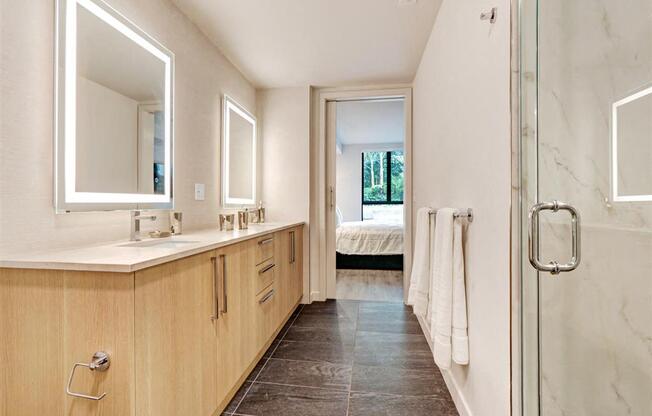 a bathroom with a shower and a sink and a mirror