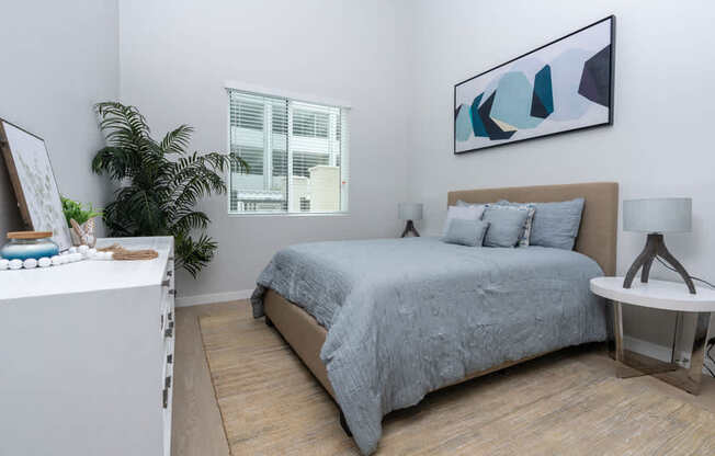 bedroom with window and painting