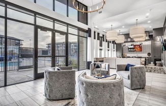 A modern living room with a large window and a view of a pool and buildings outside.