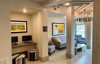 a living room with couches and a desk and a tv