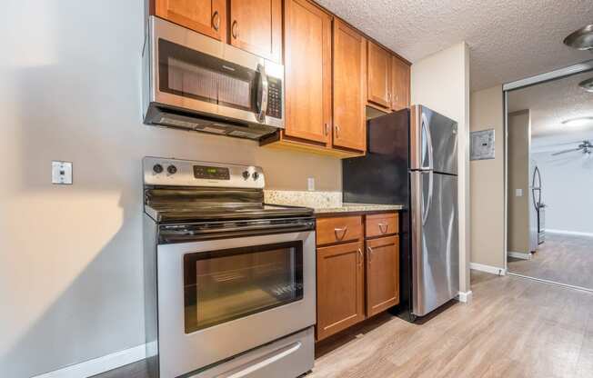 a kitchen with wooden cabinets and stainless steel appliances