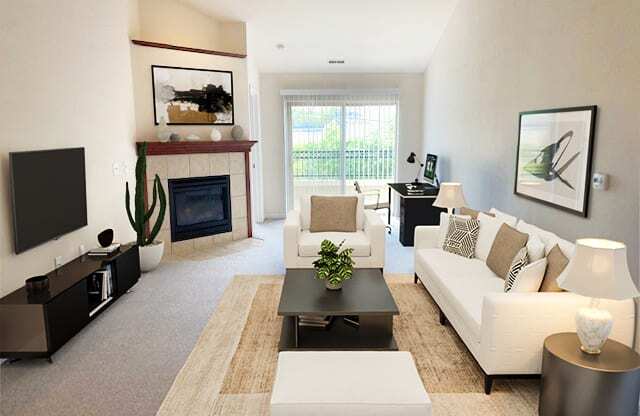 a living room with white furniture and a fireplace