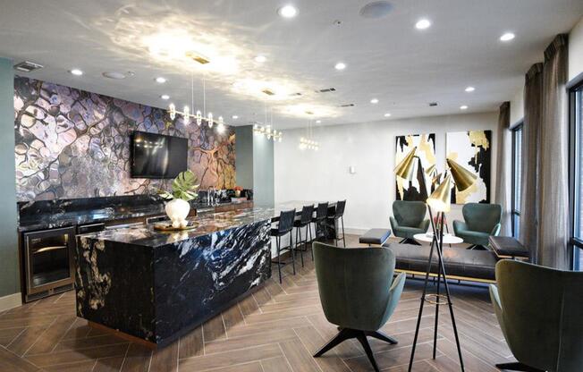 a kitchen and living room with a bar and a tv