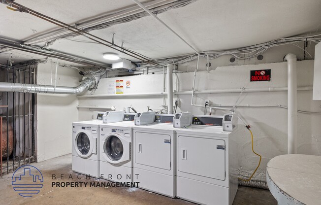 an image of a laundry room with four washing machines in it