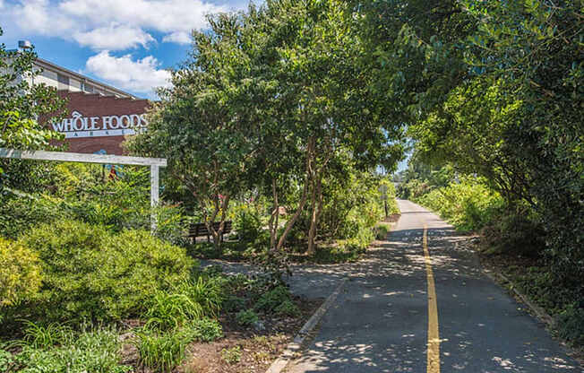 a road with trees and a building on the side of it