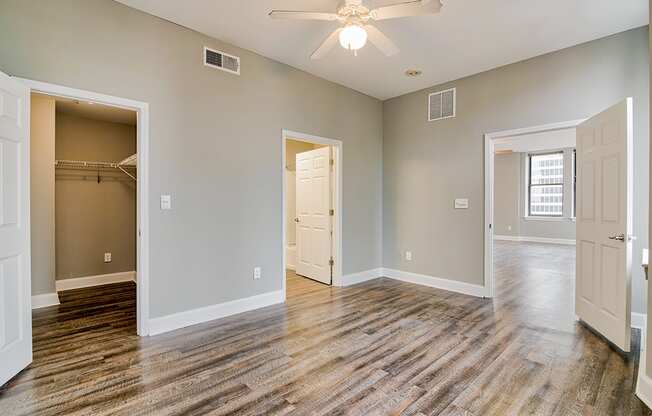 a bedroom with a ceiling fan and a closet