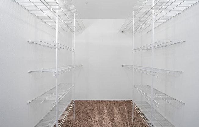 walk-in closet with white wire shelving