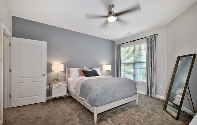 a bedroom with a bed and a ceiling fan