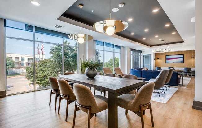 a dining room with a table and chairs and a large window
