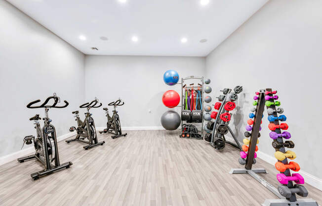 a spacious fitness room with a variety of exercise equipment