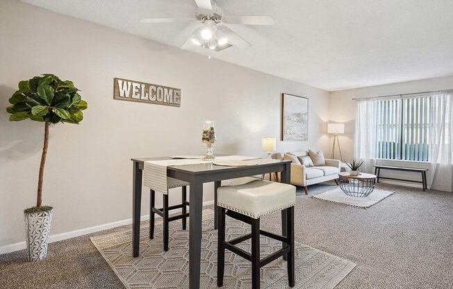 an open living room and dining room with a table